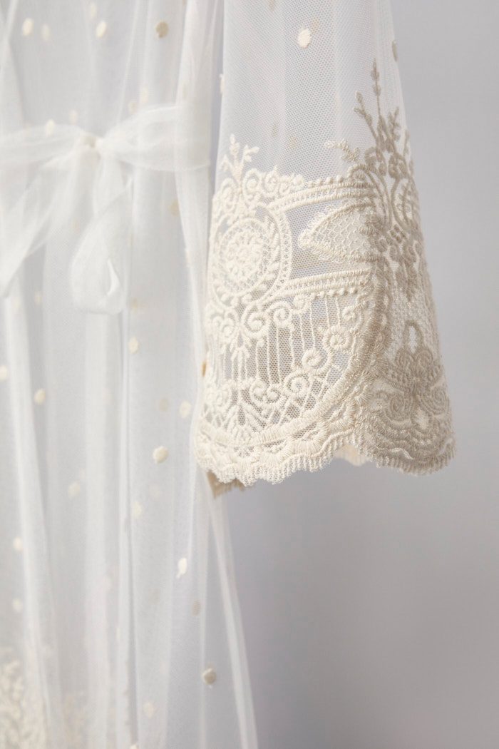 Embroidered lace hem of the Celine dotted tulle bridal robe