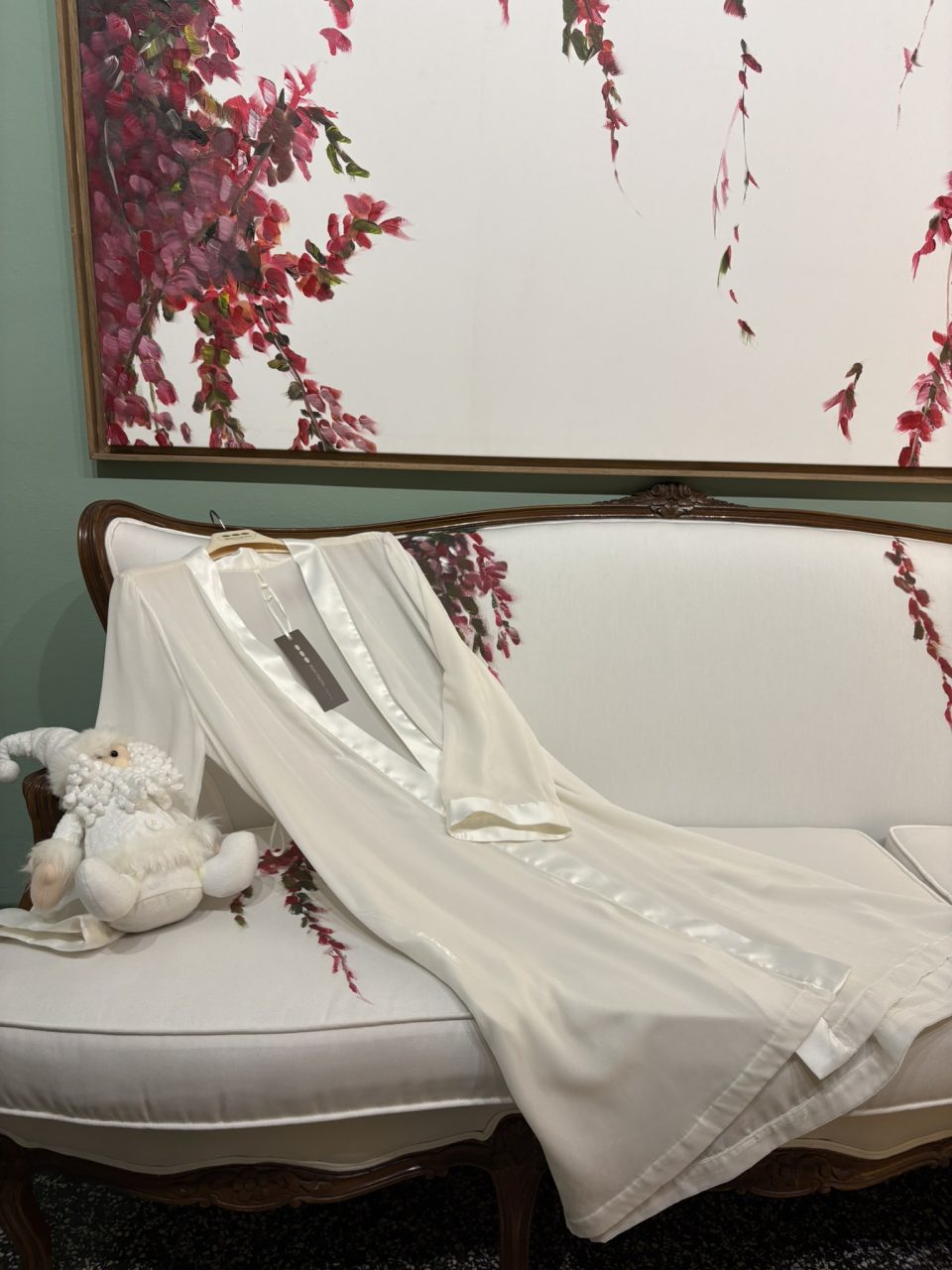 Velvet bridal robe laid on a sofa in the María Palomo atelier