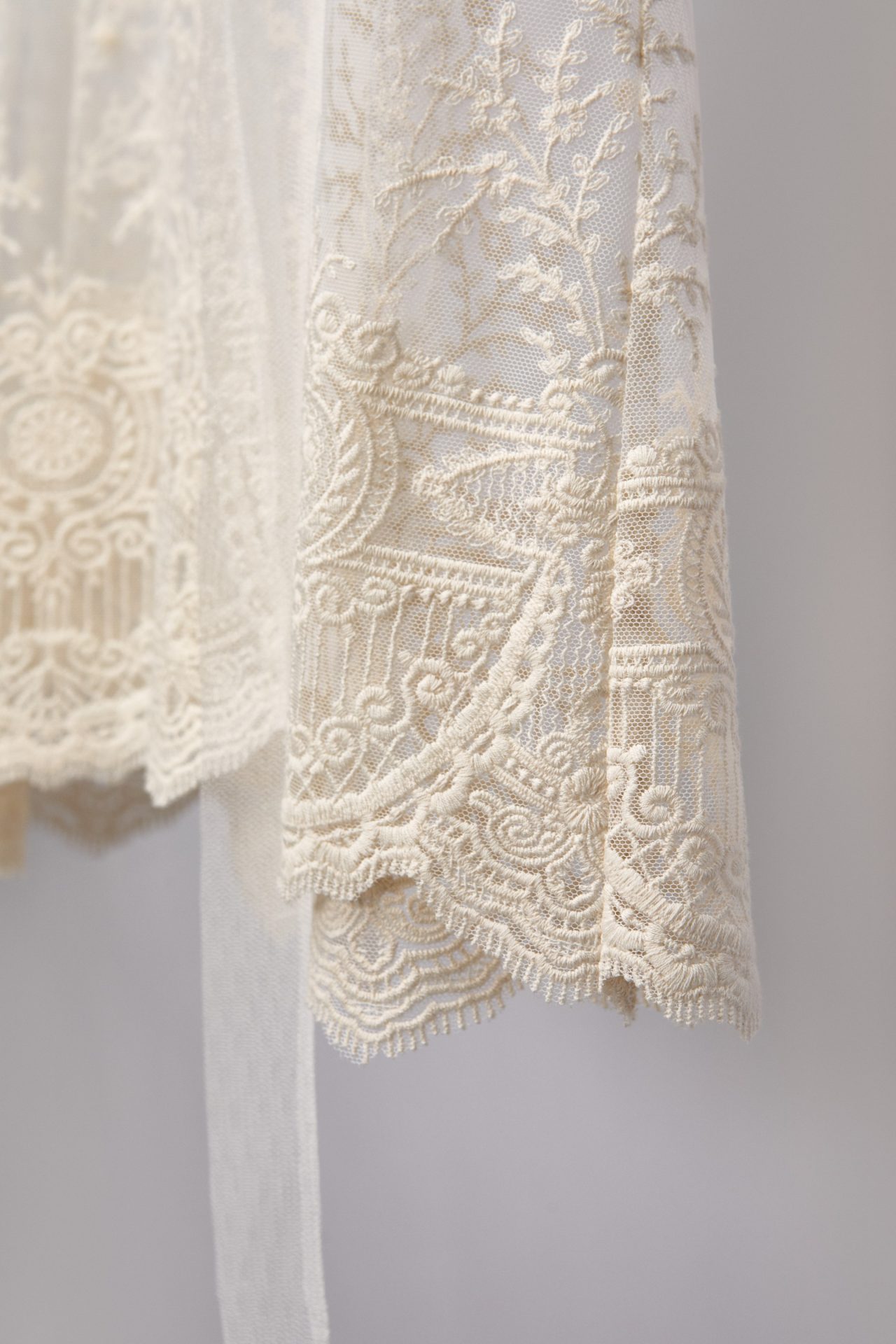 Close-up of the embroidered lace hem of the Celine bridal robe
