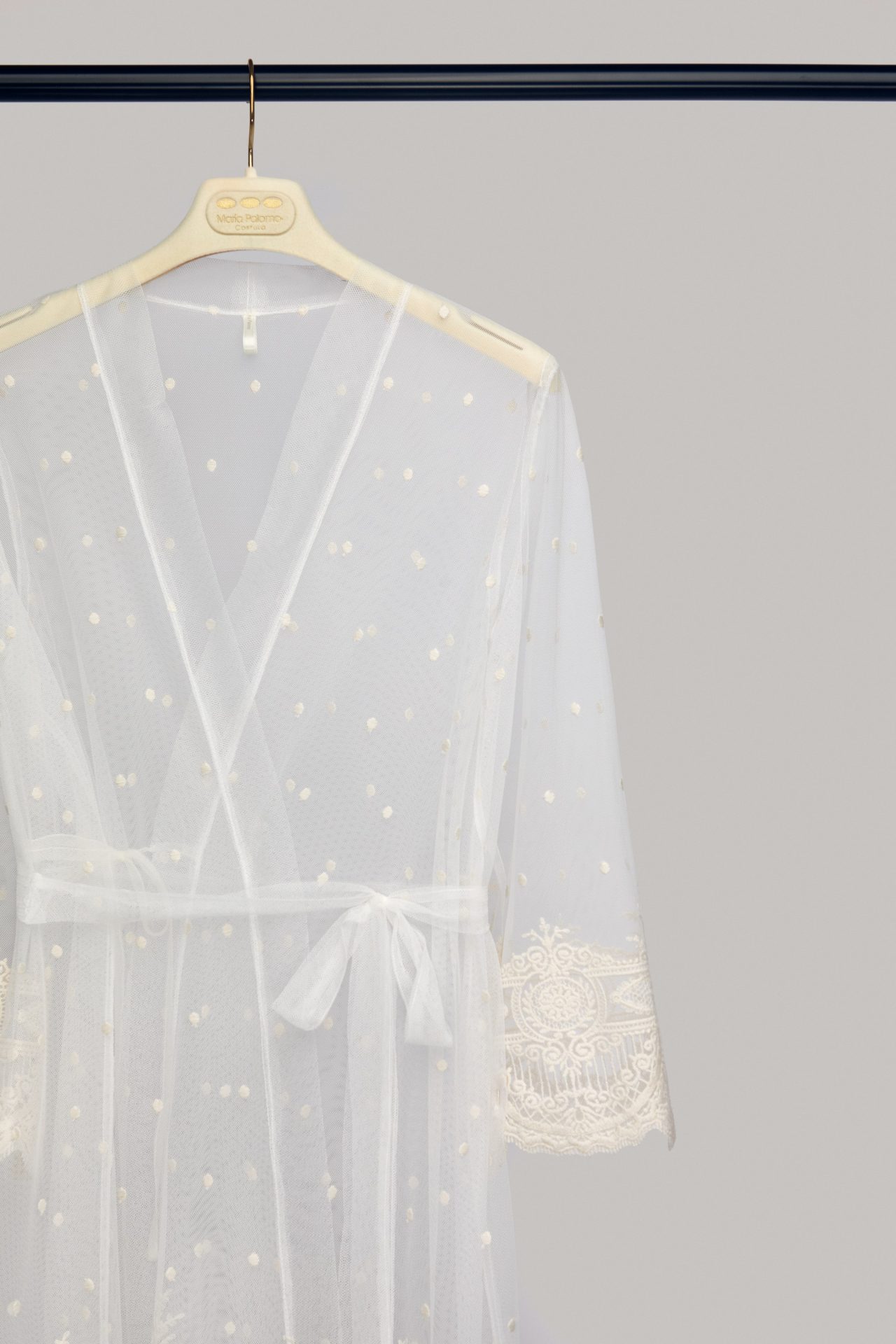 Celine bridal robe on a hanger, wrapped and tied with a bow