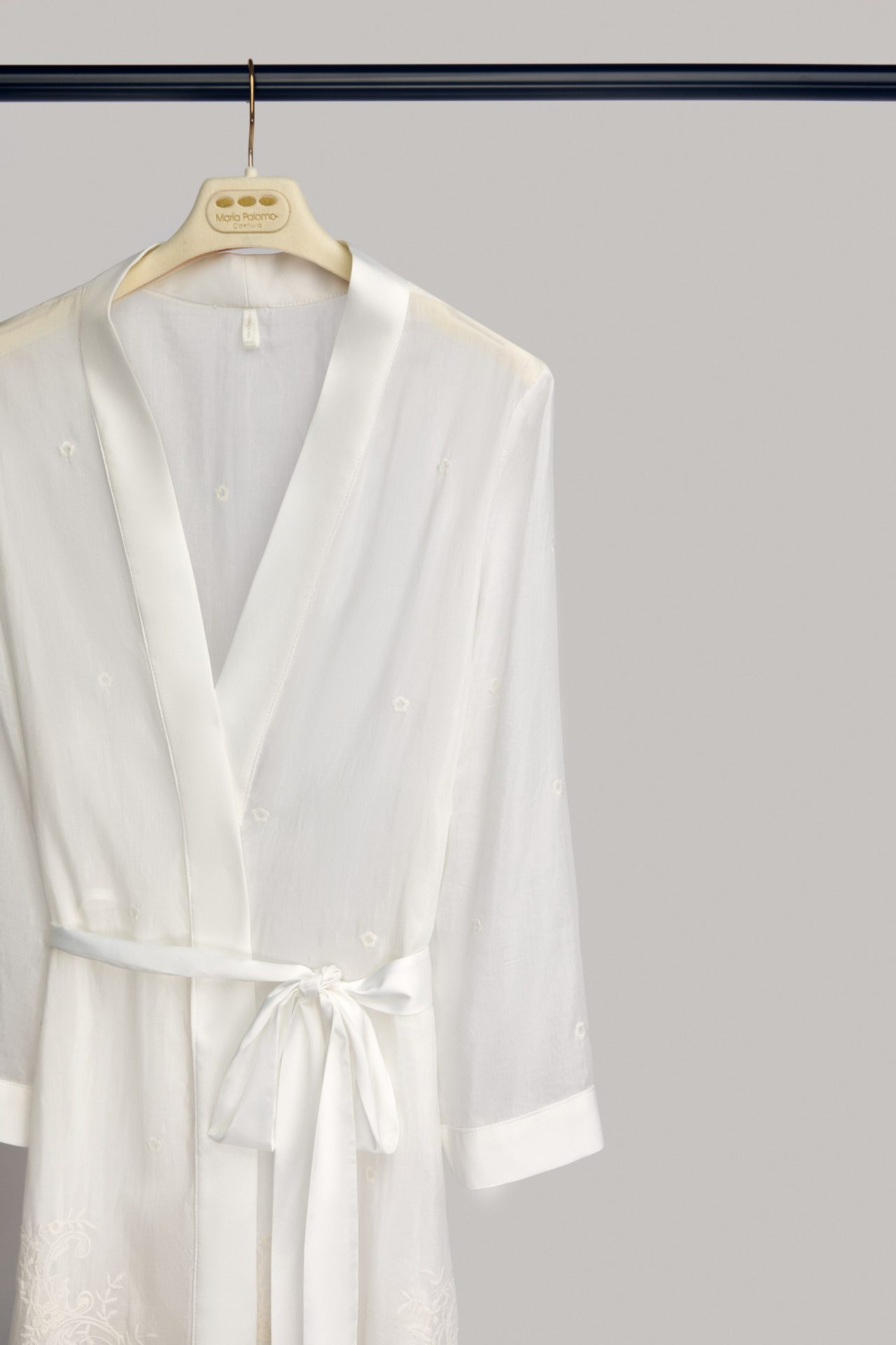 Alma bridal robe on a hanger, with satin lapel and sash