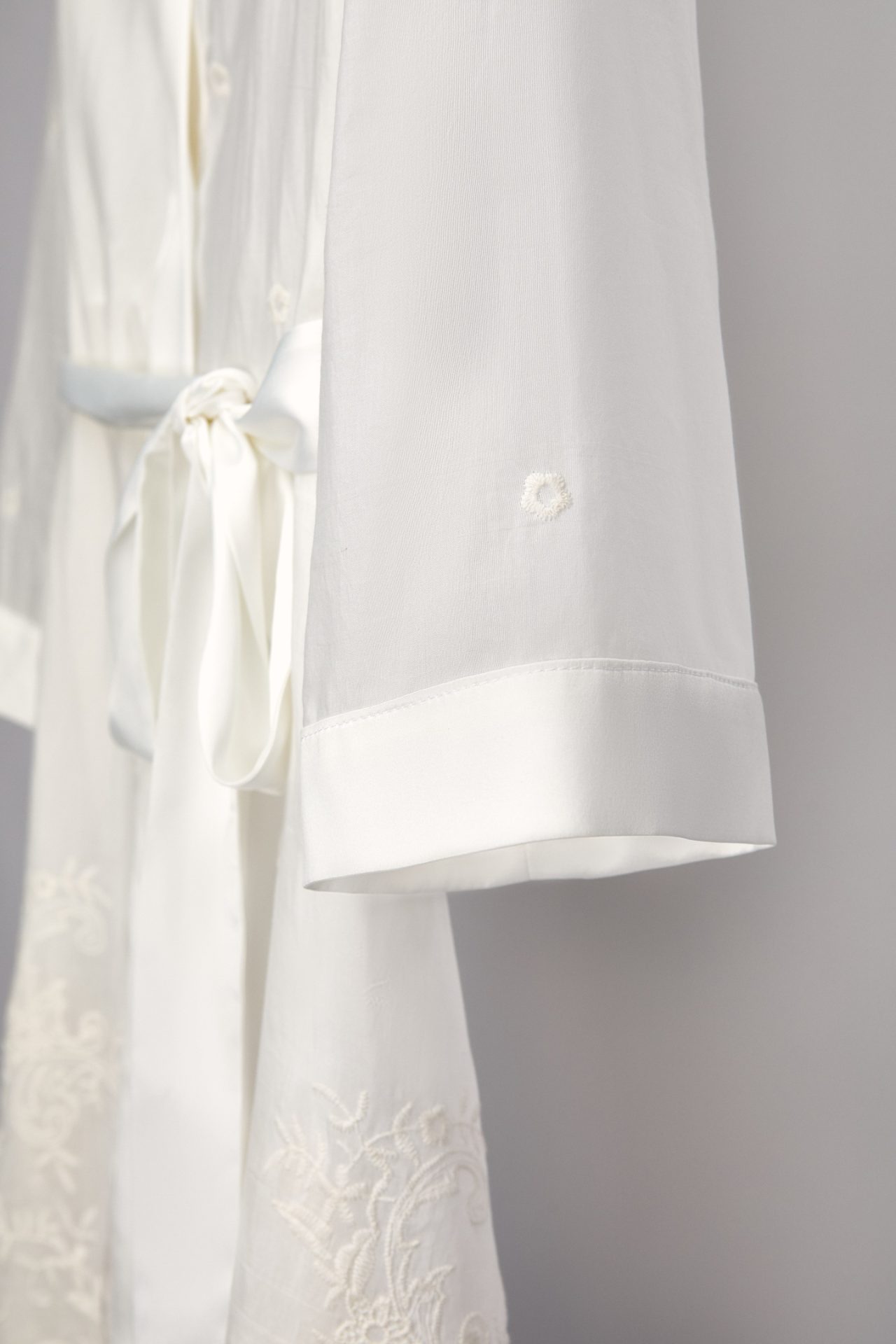 Close-up of the satin cuff and bow of the Alma bridal robe