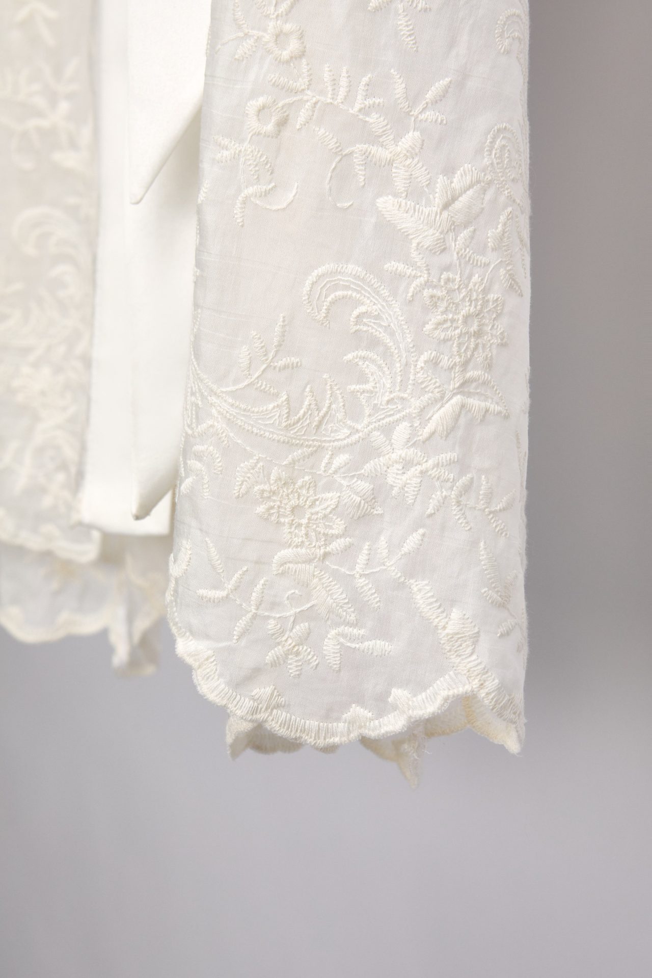 Floral embroidery and scalloped hem of the Alma bridal robe