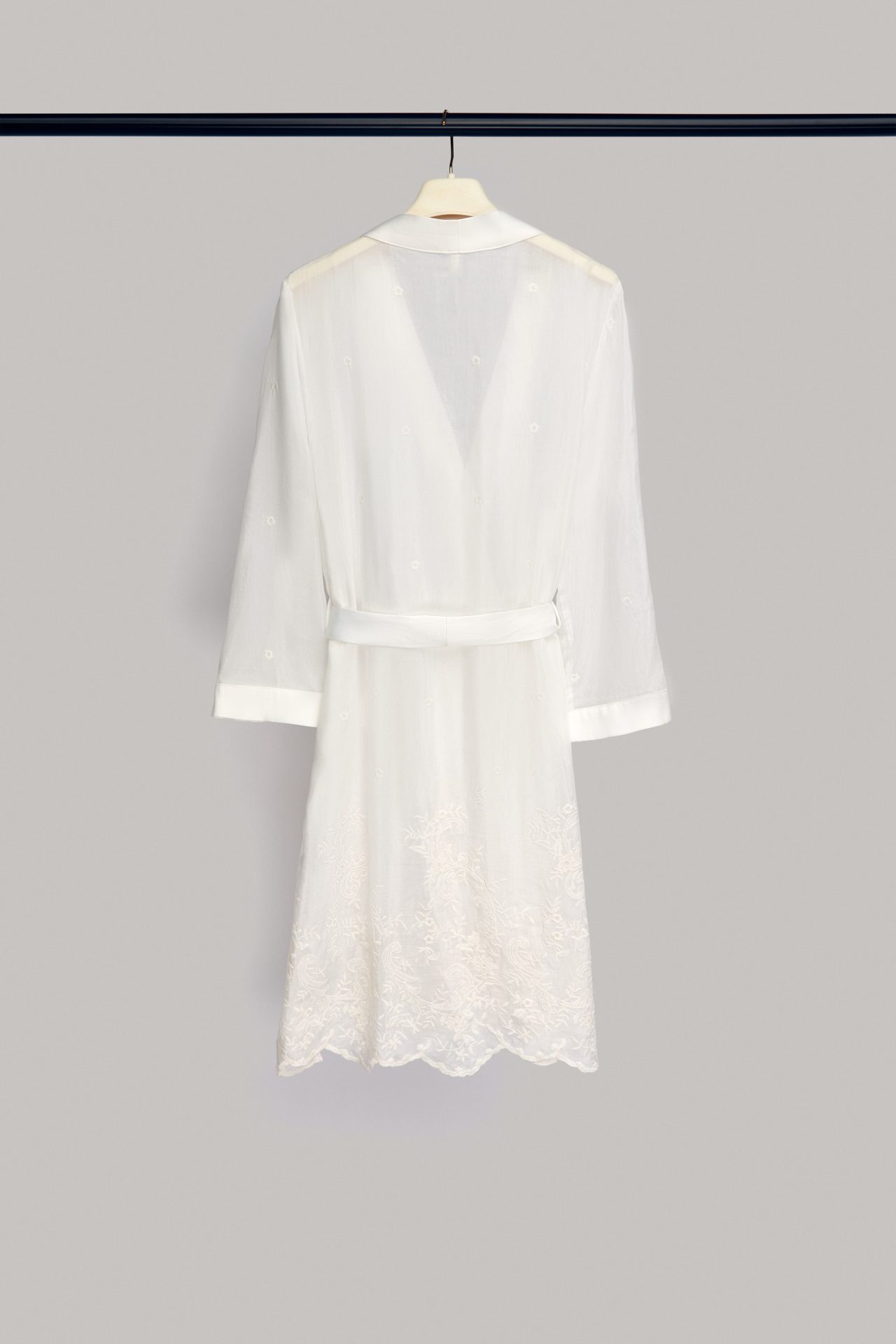 Full-length Alma bridal robe on a hanger, with embroidered hem
